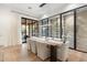 Bright dining room featuring modern lighting, a large table, and views of the patio and wine storage at 9735 E Kemper Way, Scottsdale, AZ 85255