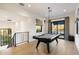 Open game room featuring a pool table, light wood floors, and access to an outdoor patio at 9735 E Kemper Way, Scottsdale, AZ 85255