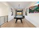 Bright game room featuring a pool table, light wood floors, and large windows showcasing scenic views at 9735 E Kemper Way, Scottsdale, AZ 85255
