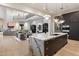 Spacious kitchen with marble countertops, dark wood cabinetry, and a view of the living area at 9735 E Kemper Way, Scottsdale, AZ 85255
