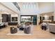 Spacious living room with a two-story ceiling, cozy seating, and an open transition to the outdoor dining at 9735 E Kemper Way, Scottsdale, AZ 85255