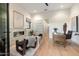 Bright living room with modern furniture, fireplace, and views of outdoor landscape at 9735 E Kemper Way, Scottsdale, AZ 85255