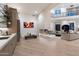 Open-concept living room boasts high ceilings and bar, complemented by a striking fireplace at 9735 E Kemper Way, Scottsdale, AZ 85255