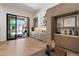 Stylish living space with a bar area that opens to an outdoor space featuring a fireplace at 9735 E Kemper Way, Scottsdale, AZ 85255