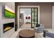 Elegant living room showcasing a fireplace and built in bar area with patio view at 9735 E Kemper Way, Scottsdale, AZ 85255