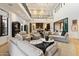 Bright, open living space with soaring ceilings, stylish furnishings, and seamless access to the kitchen at 9735 E Kemper Way, Scottsdale, AZ 85255