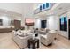 Comfortable living room showcasing a floor-to-ceiling fireplace, large TV, and cozy seating at 9735 E Kemper Way, Scottsdale, AZ 85255