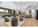 Expansive living room with contemporary furnishings, an indoor/outdoor fireplace, and an open layout at 9735 E Kemper Way, Scottsdale, AZ 85255