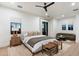 Bright bedroom features hardwood floors, ceiling fan, sitting area, and neutral tones at 9735 E Kemper Way, Scottsdale, AZ 85255