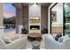 Outdoor living area features a stone fireplace with comfortable seating and TV at 9735 E Kemper Way, Scottsdale, AZ 85255