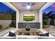 Outdoor living area features a TV, ceiling fan, and a seating area at 9735 E Kemper Way, Scottsdale, AZ 85255