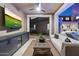 Outdoor living space features a TV, cabinets, and a view of the pool at 9735 E Kemper Way, Scottsdale, AZ 85255