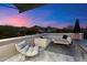 Cozy outdoor patio with stylish seating and views of the mountains at sunset at 9735 E Kemper Way, Scottsdale, AZ 85255