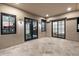 Covered patio featuring tile flooring and sleek black-framed windows, ideal for outdoor lounging and entertaining at 9735 E Kemper Way, Scottsdale, AZ 85255
