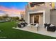 Backyard patio with artificial grass, modern outdoor furniture, and fire pit feature at 9735 E Kemper Way, Scottsdale, AZ 85255