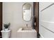 Elegant powder room features a stone sink, gold hardware, and neutral tones at 9735 E Kemper Way, Scottsdale, AZ 85255