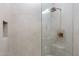 Modern shower features sleek tile, glass enclosure, and bronze fixtures in this beautiful bathroom at 9735 E Kemper Way, Scottsdale, AZ 85255