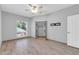 Bright bedroom with ceiling fan, closet with mirrored doors, and wood-look flooring at 101 N 7Th St # 210, Phoenix, AZ 85034