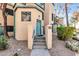 Stucco townhome with a distinctive front entrance and desert landscaping around the walkway at 101 N 7Th St # 210, Phoenix, AZ 85034