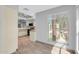 Kitchen featuring tiled counters, wood trim, wood-look flooring, and modern appliances at 101 N 7Th St # 210, Phoenix, AZ 85034