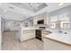 Kitchen featuring white tiled counters, light wood trim, wood-look flooring, and modern appliances at 101 N 7Th St # 210, Phoenix, AZ 85034