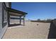 Large backyard with gravel and a covered patio area, perfect for entertaining at 18207 W Daley Ln, Surprise, AZ 85387