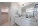 Bathroom includes dual sinks, granite countertops, and decorative mirrors at 18207 W Daley Ln, Surprise, AZ 85387