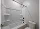 Bathroom with tub and shower combination, white fixtures, and a toilet at 18207 W Daley Ln, Surprise, AZ 85387