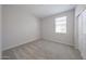 Bedroom with neutral colored carpet and natural light from window, adjacent closet at 18207 W Daley Ln, Surprise, AZ 85387