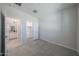 Bright, carpeted bedroom with an open door to the walk in closet, and a view to the bathroom at 18207 W Daley Ln, Surprise, AZ 85387
