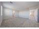 Large open bonus room featuring neutral carpet and paint throughout at 18207 W Daley Ln, Surprise, AZ 85387