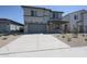 Two-story home featuring a gray exterior, a two car garage, and a neatly landscaped front yard at 18207 W Daley Ln, Surprise, AZ 85387