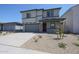 Two-story home featuring a gray exterior, a two car garage, and a neatly landscaped front yard at 18207 W Daley Ln, Surprise, AZ 85387