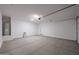 Spacious two-car garage with sealed concrete floors, overhead lighting, and ample storage potential at 18207 W Daley Ln, Surprise, AZ 85387