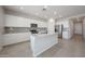 Modern kitchen with white cabinets, granite countertops, and a large island at 18207 W Daley Ln, Surprise, AZ 85387