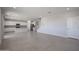 Open-concept living room showcasing tile floors and a view of the kitchen and staircase at 18207 W Daley Ln, Surprise, AZ 85387