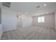 Spacious loft offering versatile living with neutral carpet and plenty of natural light from the window at 18207 W Daley Ln, Surprise, AZ 85387