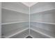 Walk-in pantry with adjustable shelving at 18207 W Daley Ln, Surprise, AZ 85387