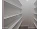 Large walk-in closet with built-in shelving and carpet flooring at 18207 W Daley Ln, Surprise, AZ 85387