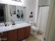 Bright bathroom with a vanity, mirror, toilet, and shower featuring neutral colors and simple decor at 1941 S Pierpont Dr # 1025, Mesa, AZ 85206