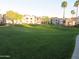 Expansive grassy green space in front of residential apartment buildings with trees and walking path at 1941 S Pierpont Dr # 1025, Mesa, AZ 85206