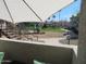 View of the community playground from the balcony with a slide, mulch, and grass at 1941 S Pierpont Dr # 1025, Mesa, AZ 85206