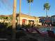 Community pool and lounge area with shade cover and palm trees at 1941 S Pierpont Dr # 1025, Mesa, AZ 85206