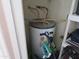 Water heater in a closet with plumbing, shelving, and household items at 1941 S Pierpont Dr # 1025, Mesa, AZ 85206