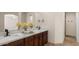 Bathroom featuring double sinks, quartz countertops, and bronze fixtures at 3747 E Harmony Ave, Mesa, AZ 85206