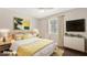 Bedroom with a neutral color scheme, decorative art, and bright natural lighting at 3747 E Harmony Ave, Mesa, AZ 85206