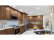Well-lit kitchen boasts stainless steel appliances, updated cabinets and countertops, and a kitchen island at 3747 E Harmony Ave, Mesa, AZ 85206