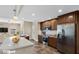 Large kitchen island, stainless steel appliances, and a view into the living area for ease of entertainment at 3747 E Harmony Ave, Mesa, AZ 85206