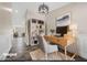 Well-lit home office with a streamlined desk, modern decor, and a view out to the dining area at 3747 E Harmony Ave, Mesa, AZ 85206