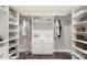 Organized walk-in closet with built-in shelving, hanging rods, and ample space for storage and organization at 3747 E Harmony Ave, Mesa, AZ 85206